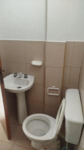 a bathroom with a toilet and a sink at ruta 8 suites in Santa Catalina