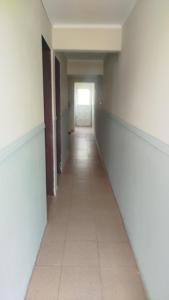 an empty corridor in a building with a hallway at ruta 8 suites in Santa Catalina