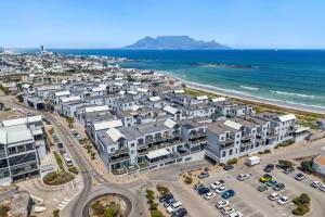 an aerial view of a city and the ocean at Eden On The Bay 174B in Bloubergstrand
