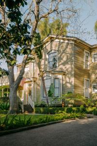 a house with a tree in front of it at Simpson House Inn in Santa Barbara