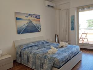 a bedroom with a bed with two wheels on it at LightHouse - Surfandwindsurferhouse in Anzio