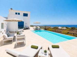 a villa with a swimming pool and the ocean at The View in Tías