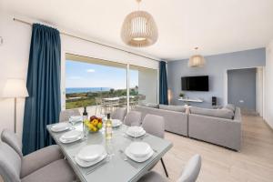 a dining room and living room with a table and chairs at The View in Tías