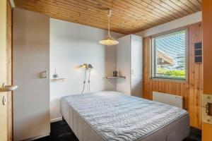 a bedroom with a bed in a room with a window at FY418-Faaborg-Fruerlund-48 in Faaborg
