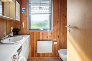 a bathroom with a sink and a toilet and a window at FY418-Faaborg-Fruerlund-48 in Faaborg +16 photos
