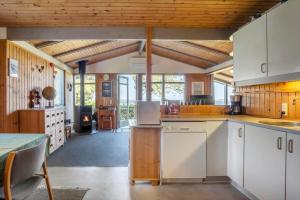a kitchen with white cabinets and a wooden ceiling at FY418-Faaborg-Fruerlund-48 in Faaborg