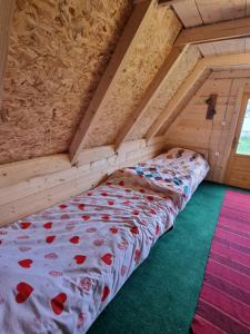 a bed in the attic of a room at Auto kamp Runolist in Rožaje +2 photos