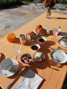 a table with a breakfast of food and orange juice at Chez Sophie in Plescop +6 photos