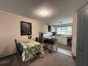 a kitchen with a table and chairs and a kitchen with a sink at Beautiful Spacious Flat in Oxford +4 photos
