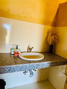 a bathroom with a sink on a counter at Fayoum Desert Camp in Qaryat Ḩātim aţ Ţāʼī