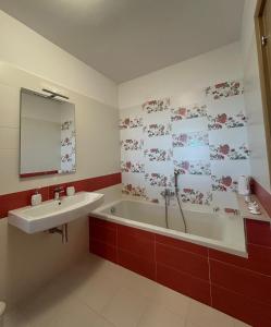 a bathroom with a bath tub and a sink at La casa di John in Guglionesi +44 photos