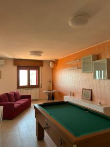 a living room with a pool table in it at La casa di John in Guglionesi
