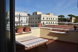 a balcony with a bench sitting on top of a building at LightHouse - Surfandwindsurferhouse in Anzio
