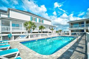 a swimming pool in front of a house at Carolina Blue in North Myrtle Beach