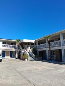 a large building with palm trees in a parking lot at Carolina Blue in North Myrtle Beach