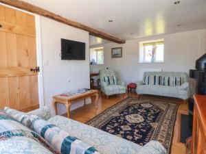a living room with a couch and a tv at The Granary in York