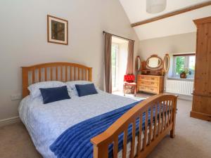 a bedroom with a bed and a dresser and a mirror at The Granary in York