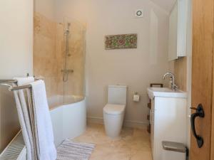 a bathroom with a tub and a toilet and a sink at The Granary in York +17 photos