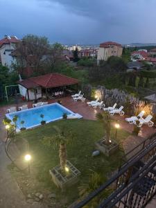 a backyard with a swimming pool and lounge chairs at Serenity Hill-Bulharsko U Nás in Sveti Vlas