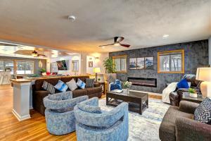 a living room with couches and chairs and a fireplace at 6BR Luxury Mountain Retreat - Hot Tub, Game Room, Lake, Beach, Karaoke, Bar, Poconos in Albrightsville
