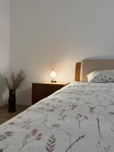 a bedroom with a bed and a lamp on a table at Holiday house Katrca in Pivka