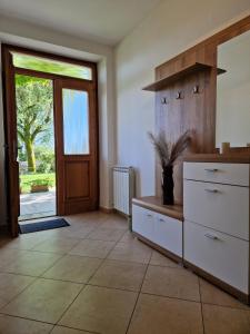 a room with a dresser and a door with a window at Holiday house Katrca in Pivka +14 photos