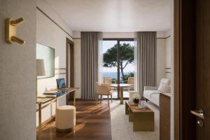 a living room with a couch and a table at MarePineta Resort in Milano Marittima
