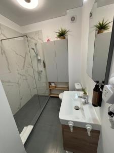 a bathroom with a shower and a sink at TheBlueEscape Apartment in Năvodari +19 photos