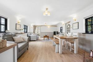 a living room with a couch and a table at Five Acres Cottage in Rickmansworth