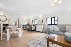 a living room with a couch and a table at Five Acres Cottage in Rickmansworth
