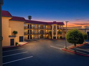 a hotel parking lot in front of a hotel at Rancho San Diego Inn & Suites in El Cajon