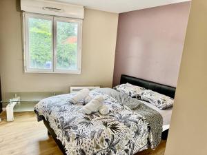 a bedroom with a bed with two pillows on it at AMOUR PARIS -Orly 10min Bus -RER C Tram T9 in Vitry-sur-Seine