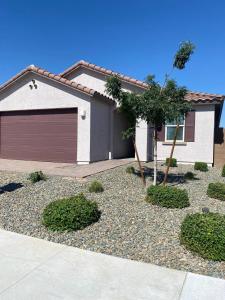 a house with a garage and a tree in front of it at Clark's Luxury Apartment in Phoenix