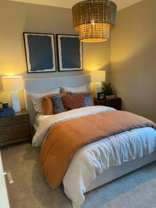 a bedroom with a bed and a chandelier at Clark's Luxury Apartment in Phoenix