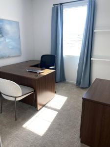 a office with a desk and a chair and a window at Clark's Luxury Apartment in Phoenix +1 photo