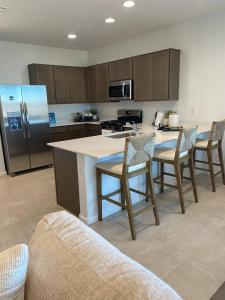 a kitchen with a table and chairs and a refrigerator at Clark's Luxury Apartment in Phoenix
