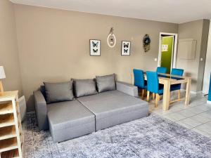 a living room with a couch and a table at AMOUR PARIS -Orly 10min Bus -RER C Tram T9 in Vitry-sur-Seine