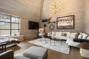 a living room with a couch and a table at Large modern cabin from 2023 for rent in Dirdal