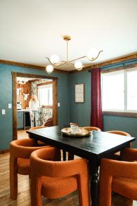 a dining room with a table and chairs at Family Fun Indoor Play Zone UP Waterfalls in Bessemer