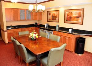 a kitchen with a wooden table and chairs at Slopeside Hotel, A Vail Resorts Property in Champion
