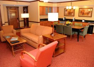 a living room with furniture and a dining room at Slopeside Hotel, A Vail Resorts Property in Champion