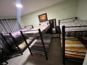 a room with three bunk beds in it at Ibiza Hostel Suites in Santa Cruz de la Sierra