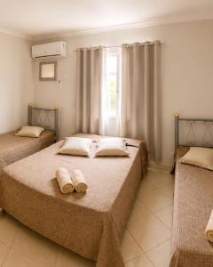 a bedroom with two beds with towels on them at Hotel Eldorado de Salinas in Salinas