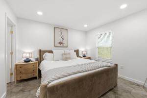 a bedroom with a large bed and a window at Decantur Inn 3 King Bedrooms in Lafayette