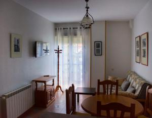 a living room with a couch and a table at La flor del cerezo in Piornal