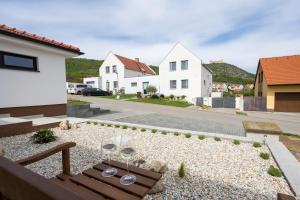 a backyard with a bench and wine glasses at Dům Pavlov in Pavlov