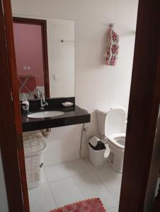 a bathroom with a sink and a toilet at Casa da Helenice in São Roque de Minas