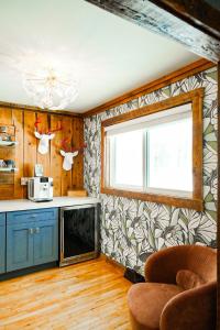 a kitchen with a counter and a window and a microwave at Family Fun Indoor Play Zone UP Waterfalls in Bessemer