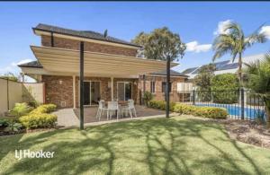 a house with a patio and a swimming pool at MawsonLakes Lake view Villa in Mawson Lakes