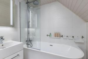 a bathroom with a shower and a tub and a sink at Pear Tree Cottage, Dunblane in Dunblane +45 photos